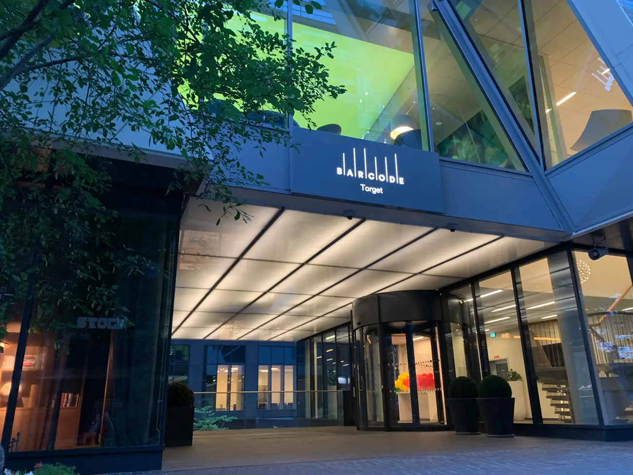 The entrance of a modern commercial building in Oslo